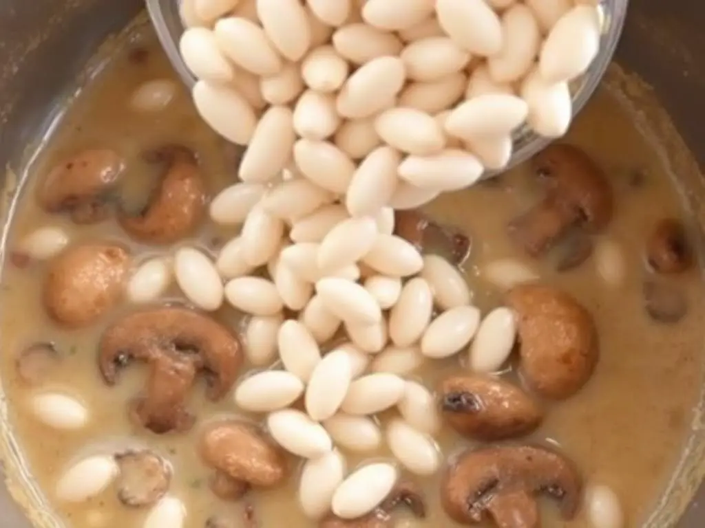 Adding white beans to the Creamy Mushroom White Bean Stew