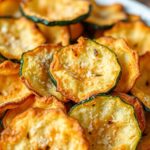 Crispy baked Parmesan zucchini chips arranged on a serving plate