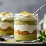 Layered Matcha Tiramisu Chia Pudding in a glass jar with a spoon